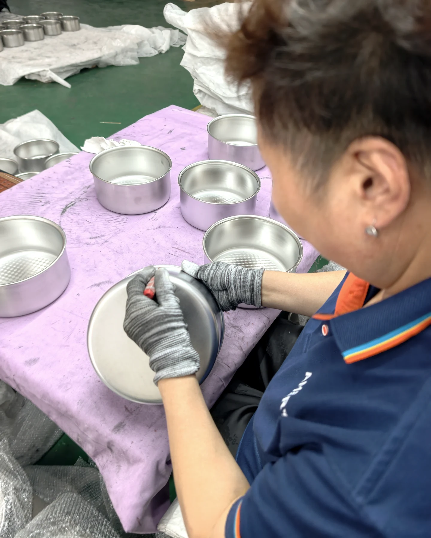 ANMEI quality inspector checking a cookware component